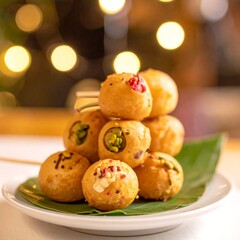 Stack of bite-sized golden pastries on a plate with garnish