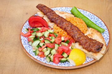 Delicious kebab plate served with fresh vegetables and rice
