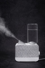 Air Humidifier with Steam on Black Background