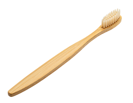 Natural bamboo toothbrush on a black backdrop. Bristles are light tan, and the handle's wood has a visible grain