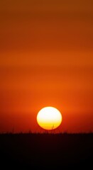 Intense fiery orange sunset or sunrise symbolizing extreme heat and global warming environmental crisis ,bright ,atmosphere ,blazing