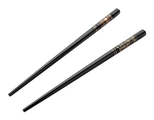 Pair of black chopsticks, one with intricate golden design at the end, isolated on a black background