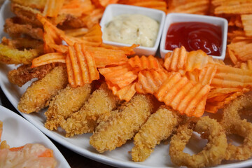 Snack Platter, captured on October 24, 2025. Crispy fries, onion rings, nuggets, and sauces served on a wooden board, tasty assortment perfect for sharing and casual dining visuals
