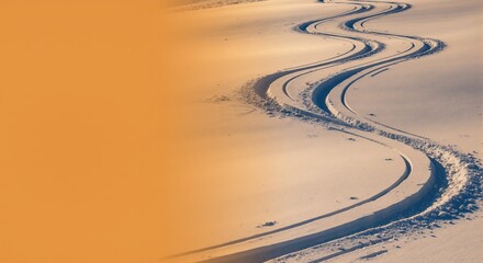Winding ski tracks in fresh snow. Abstract winter path at sunset with minimalist orange copy space