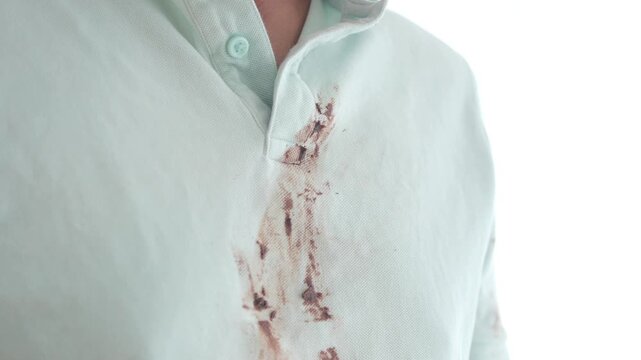 Messy chocolate spill on white shirt during snack time