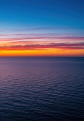 Obraz premium A stunning, wide vista showing a brilliant orange and pink tropical sunset descending below the vast horizon of the deep blue ocean water ,wide angle ,seascape ,water