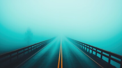 A foggy road stretching into the distance, creating a sense of mystery and solitude.