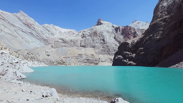 Big Allo lake view with mountain range and turquoise water in Fann mountains Pamir Alay Tajikistan