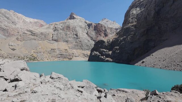 Big Allo lake view with mountain range and turquoise water in Fann mountains Pamir Alay Tajikistan