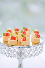 A rich dessert table filled with fresh fruit, delicious pastries and exquisite sweets is perfect for event catering