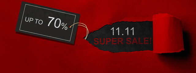 Top view of red ripped paper and text of 11.11 super sale with up to 70% text on the label tag....