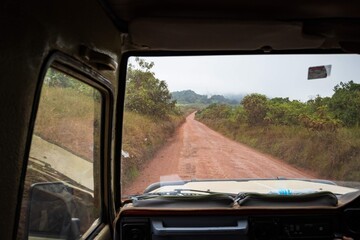 Driving View from Inside a 4x4 Vehicle on a Remote Dirt Road Through the Jungle in Africa