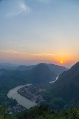 Mountain landscape at sunset. forest and green slopes