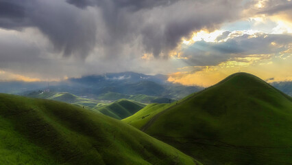 Mountain landscape at sunset. forest and green slopes