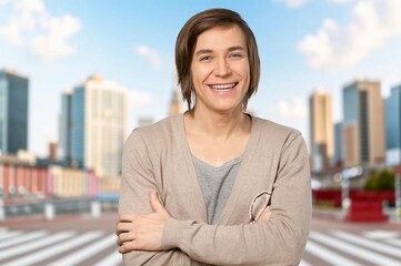 individual portrait of one happy young male standing outside