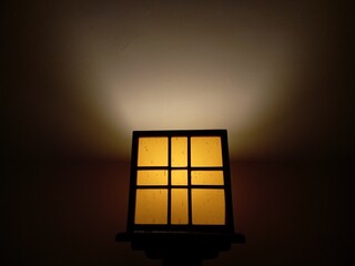 Aesthetic yellow box lamp mounted on the wall as a night light
