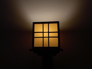 Aesthetic yellow box lamp mounted on the wall as a night light