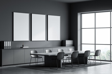 Contemporary office interior with three empty poster frames on a dark wall, clean layout with table and chairs, bright window view. 3D Rendering