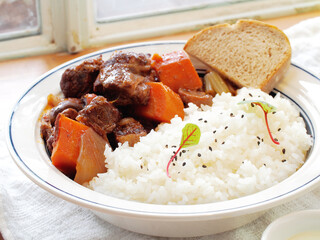 Red wine braised beef ribs with rice in white plate  