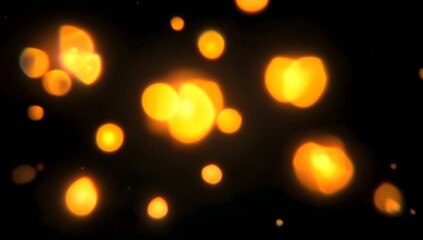 Abstract glowing orbs of warm golden orange light softly floating and shimmering against a deep dark black background creating a magical ethereal atmosphere