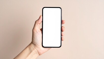 Close up of a person's hand holding a modern smartphone with a blank white screen isolated on a solid beige background highlighting technology and communication