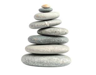 Stack of seven smooth gray stones balancing in zen-like arrangement against a clean black background
