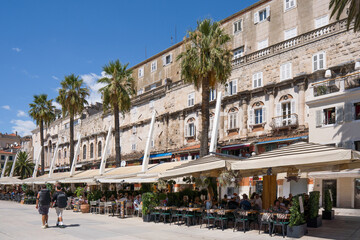 People enjoying cafes along the Riva promenade in Split, Croatia