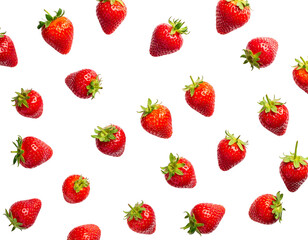 Strawberries scattered on black, bright red fruit with green leafy tops creating a vibrant, natural pattern