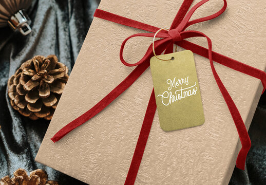 Festive Gift With Red Ribbon And Tag Mockup PSD