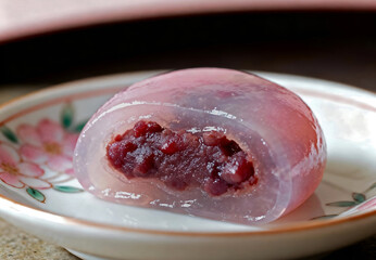 Close-up of translucent Mizumanju filled with red bean paste served on a floral ceramic plate