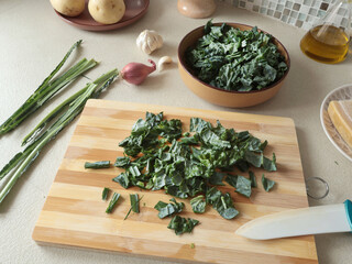 Peeled kale on wooden board at home. Healthy eating, farm produce.