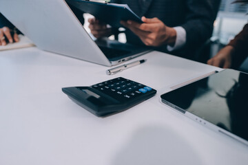 Fototapeta premium Accounting company provide finance and taxation planning for profitable cash flow, Auditor and accountant team working in office, analyze financial data and accounting record with calculator.Insight