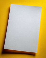 Blank white sheet of paper on a yellow background