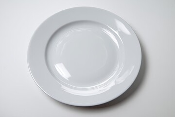 Empty round white plate on white surface