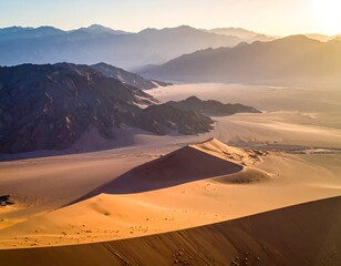 Aerial shot of sunlit desert and mountains in the early morning light