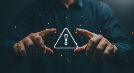 A person's hands delicately cradle a glowing attention sign, conveying a sense of vigilance and the presence of danger. The composition, set against a dark background.