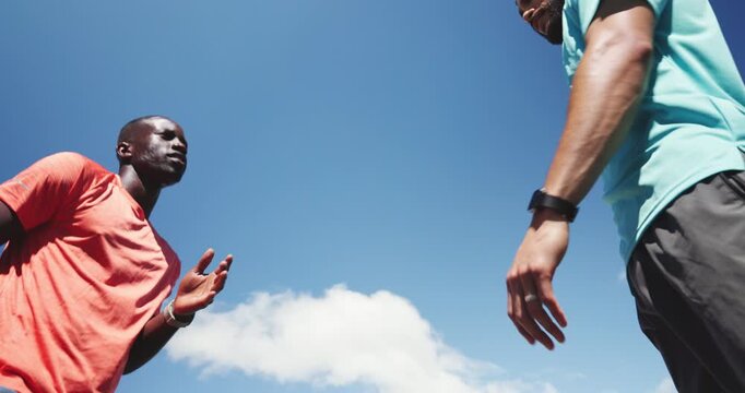 Fitness, personal trainer or men talk for running tips, motivation or instructions for speed training. Practice, below or people with teamwork for workout, advice or guide client for outdoor exercise