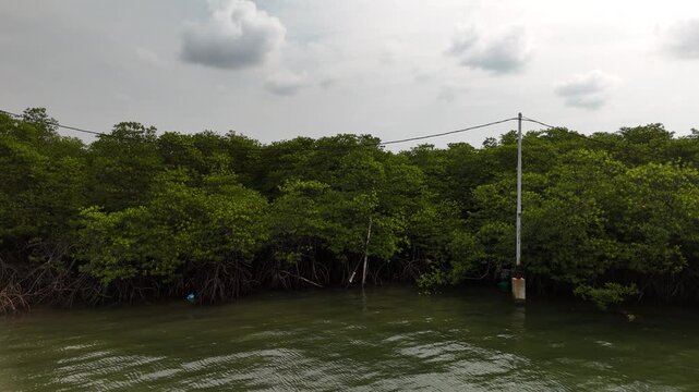 Aerial shot of traditional coastal stilt houses with the iconic Barelang Bridge in the background connecting Batam Lempang and Galang islands highlighting island life and infrastructure