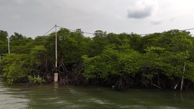 Aerial shot of traditional coastal stilt houses with the iconic Barelang Bridge in the background connecting Batam Lempang and Galang islands highlighting island life and infrastructure