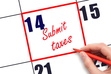 14 th day of the month.  Hand writing Submit taxes reminder and drawing red frame on calendar with red pen on white background. Business concept. Planning and scheduling