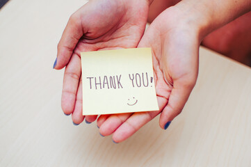Gratitude gesture thank you note personal space image indoor setting close-up appreciation