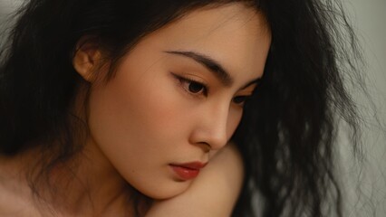 Fototapeta premium A soft side profile in natural light, emphasizing the woman’s calm expression and delicate facial lines.