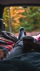Cozy autumn escape  a close up of a man relaxing with coffee in a car surrounded by nature