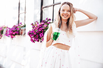 Young beautiful smiling hipster woman in trendy summer clothes. Sexy carefree model posing in the...