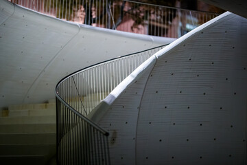 Spiral Ascent: Curved Staircase and Wavy Wall at Night