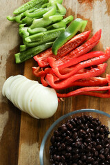 Freshly cut red and green peppers, onions, and black beans
