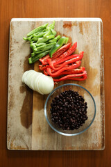 Freshly cut red and green peppers, onions, and black beans