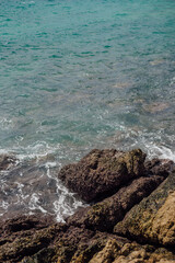 Rocky Shoreline and Turquoise Water at Yanui Beach, Phuket, Thailand