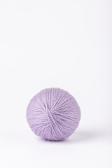 Lavender yarn ball, vertical image with white background, simple and harmonious composition with copy space. Concept of delicate handmade crafts