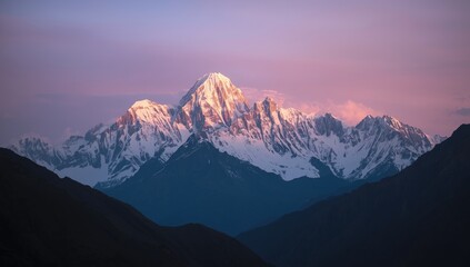 Majestic snow-covered mountain range at sunrise casts golden light onto the peaks, with a vibrant and pastel-colored sky above, and dark mountains in the foreground, offering a dramatic landscape...